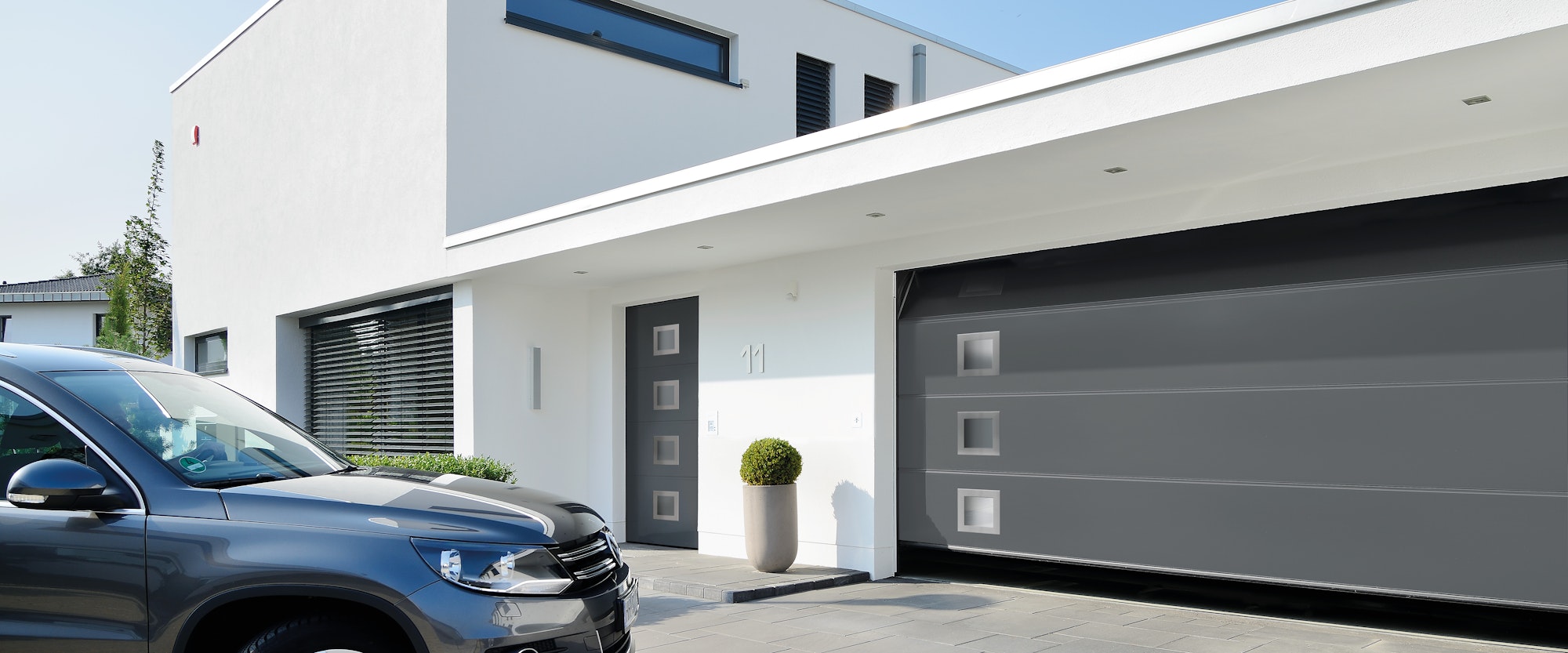 Contemporary home with a wide gray garage door